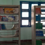 Empty bookshelves in a rural school library in Vietnam, showing severe shortage of age-appropriate reading materials