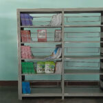 Empty bookshelves in a rural school library in Vietnam, showing severe shortage of age-appropriate reading materials