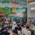 Students reading books in a newly built reading corner at a rural Vietnamese school library